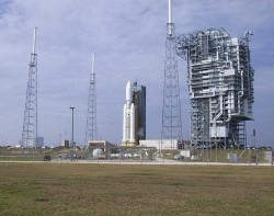 A Titan 4 rocket pre-launch as the gantry rolls back. The lightning protection system surrounds the pad (Justin Ray/Spaceflight Now)