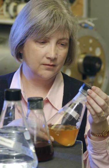 Uurine-recycling: Engineer Cindy Hutchens looks at urine treated with chemicals. Credit: NASA/MSFC