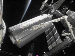 The Japanese Kibo Module is moved from the US space shuttle Discovery cargo bay (AFP/NASA)