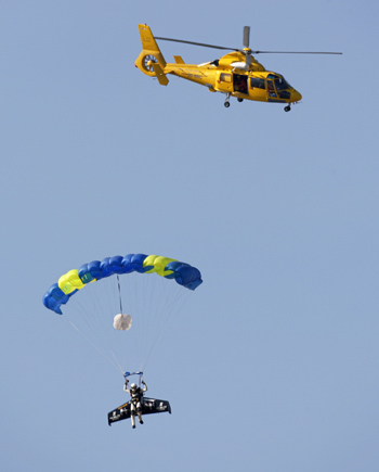 About 15 minutes later Rossy parachuted towards his landing site near Dover after making the crossing (Adrian Dennis/AFP/Getty) About 15 minutes later Rossy parachuted towards his landing site near Dover after making the crossing (Adrian Dennis/AFP/Getty)
