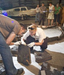 Matt Gasch of NASA Ames and Betsy Pugel of NASA Goddard examine the remains of a 1966 Apollo test vehicle heat shield (Smithsonian Museum/Eric Long)