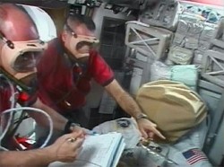 Astronauts Garrett Reisman (left) and Rick Linnehan wear oxygen masks as they check their suits in preparation for their ISS spacewalk last March (NASA)