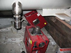 Obvious damage to concrete, where a magnet has been lifted off its mount (the red boxes) that secured it to the floor (CERN)