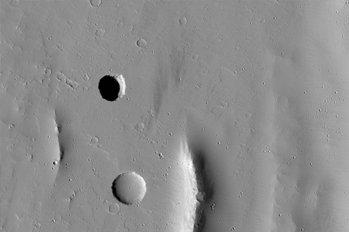 Pit on Mars in Tractus Fossae.  Credit: NASA/JPL/U of Arizona