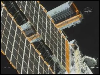 The S6 blanket box before deploy (behind the arrays unfurled during a previous mission). Credit: NASA TV The S6 blanket box before deploy (behind the arrays unfurled during a previous mission). Credit: NASA TV