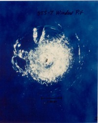 Space debris impact on Space Shuttle window.  Credit: NASA