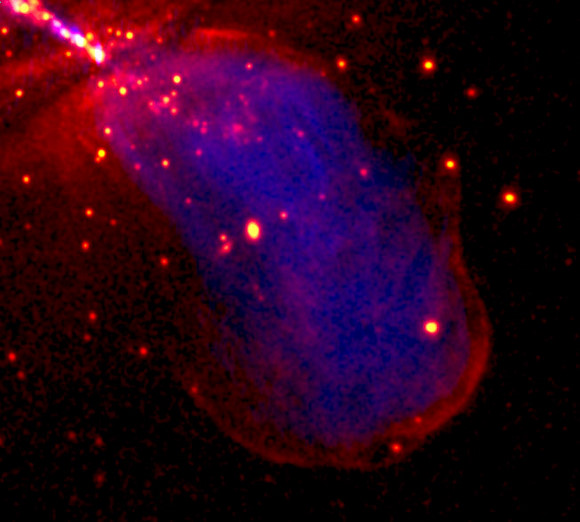 The image shows in red the X-ray emission produced by high-energy particles accelerated at the shock front where Centaurus A's expanding radio lobe (shown in blue) collides with the surrounding galaxy. (In the top-left corner X-ray emission from close to the central black hole, and from the X-ray jet extending in the opposite direction can also be seen.) Credit: NASA The image shows in red the X-ray emission produced by high-energy particles accelerated at the shock front where Centaurus A's expanding radio lobe (shown in blue) collides with the surrounding galaxy. (In the top-left corner X-ray emission from close to the central black hole, and from the X-ray jet extending in the opposite direction can also be seen.) Credit: NASA
