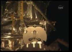The view from the shuttle's RMS camera of the grapple fixture on Hubble. NASA TV. The view from the shuttle's RMS camera of the grapple fixture on Hubble. NASA TV.