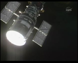Screenshot of first view of Hubble from Atlantis on NASA TV. Screenshot of first view of Hubble from Atlantis on NASA TV.