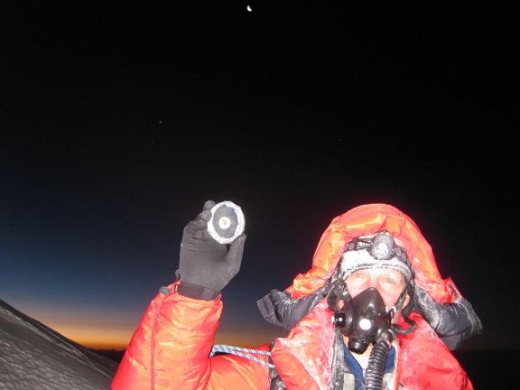 As the sun rises on Mt. Everest, former astronaut Scott Parazynski holds rocks from the Moon that he brought to the summit. Credit: OnOrbit.com As the sun rises on Mt. Everest, former astronaut Scott Parazynski holds rocks from the Moon that he brought to the summit. Credit: OnOrbit.com