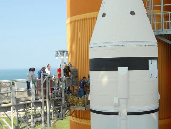 workers on Kennedy Space Center's Launch Pad 39A prepare to remove the 7-inch quick disconnect and flight seal from the Ground Umbilical Carrier Plate, or GUCP, on space shuttle Endeavour's external fuel tank. Teams are removing the hardware to change out seals in the internal connection points. The GUCP is the overboard vent to the pad and the flare stack where the vented hydrogen is burned off. Credit: NASA Workers on Kennedy Space Center's Launch Pad 39A prepare to remove the 7-inch quick disconnect and flight seal from the Ground Umbilical Carrier Plate, or GUCP, on space shuttle Endeavour's external fuel tank. Teams are removing the hardware to change out seals in the internal connection points. The GUCP is the overboard vent to the pad and the flare stack where the vented hydrogen is burned off. Credit: NASA
