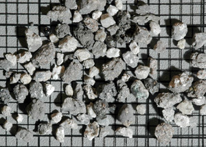 Small rock fragments from the lunar "soil" collected by the Apollo 11 astronauts in 1969. The background grid spacing is 2 mm. Credit: WUSTL Small rock fragments from the lunar "soil" collected by the Apollo 11 astronauts in 1969. The background grid spacing is 2 mm. Credit: WUSTL