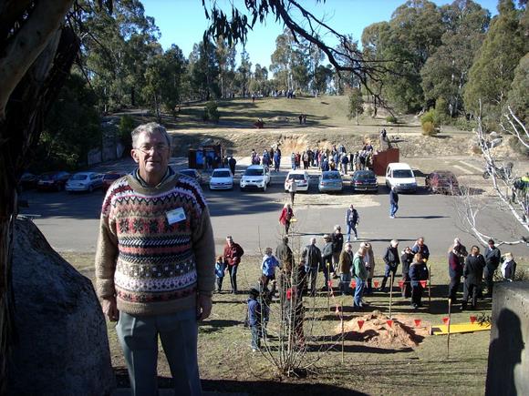 Bruce Ekert on July 21, 2009 at the Honeysuckle Creek site, taken from the position of the communications tower. Below is the concrete pad which marks the position of the building.  At the very back of the photo is the place where the HSK Dish was situated. Courtesy Bruce Ekert 