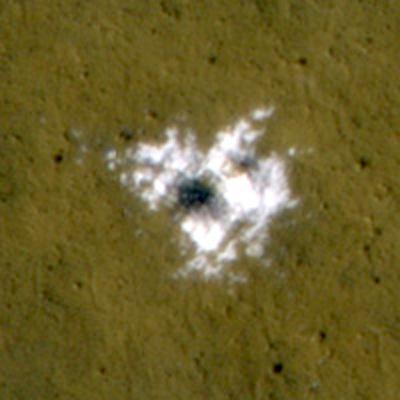The HiRISE camera on NASA's Mars Reconnaissance Orbiter took this image of a new, 8-meter (26-foot)-diameter meteorite impact crater in the topographically flat, dark plains within Vastitas Borealis, Mars, on November 1, 2008. The crater was made sometime after Jan. 26, 2008. Bright water ice was excavated by, and now surrounds, the crater. This entire image is 50 meters (164 feet) across. Credit: NASA/JPL-Caltech/University of Arizona The HiRISE camera on NASA's Mars Reconnaissance Orbiter took this image of a new, 8-meter (26-foot)-diameter meteorite impact crater in the topographically flat, dark plains within Vastitas Borealis, Mars, on November 1, 2008. The crater was made sometime after Jan. 26, 2008. Bright water ice was excavated by, and now surrounds, the crater. This entire image is 50 meters (164 feet) across. Credit: NASA/JPL-Caltech/University of Arizona