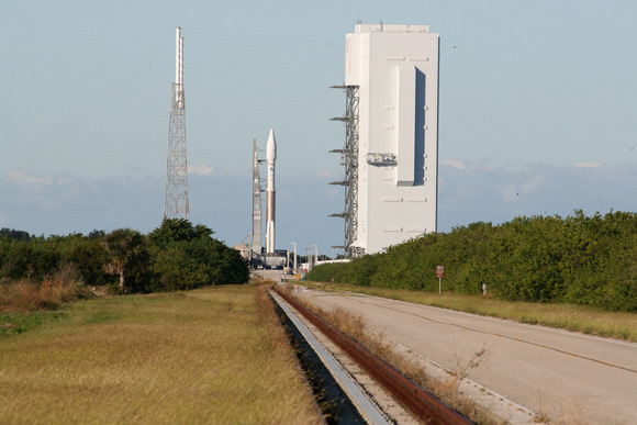 Atlas 5 rocket sits atop mobile launch platform at launch pad at Complex 41, Cape Canaveral, Florida on a cloudless day just a few hours prior to the scheduled post midnight launch on 14 November 2009. Note lightings masts at left and Vertical Integration Facility at right where rocket components are assembled. Credit: Ken Kremer