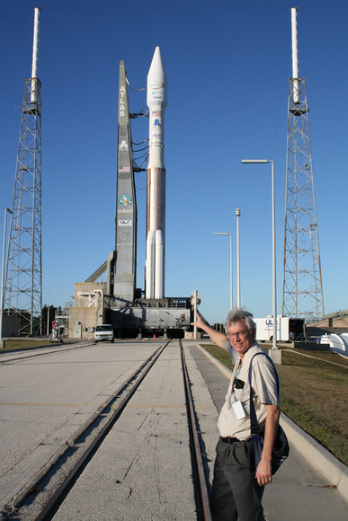 Ken Kremer with the Atlas launch vehicle at Pad 41 which will fly in the 431 configuration with 3 solid rocket boosters attached to the first stage and a single engine white colored Centaur upper stage. The Atlas 5 was rolled out to launch pad on Nov 12. Note tracks at center. The Intelsat satellite is encapsulated in a 4 meter wide extra extended payload fairing. A similar Centaur stage impacted the moon as part of the LCROSS mission.
