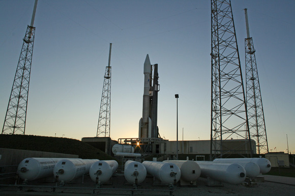Atlas 5 rocket at sunset surrounded by 4 lightening masts at pad 41. Multiple tanks of compressed gaseous nitrogen at 4800 psi in foreground. A technical glitch with the ORCA electronics unit critical for flight control forced a scrub for what would have been the 19th flight of an Atlas 5. Credit: Ken Kremer