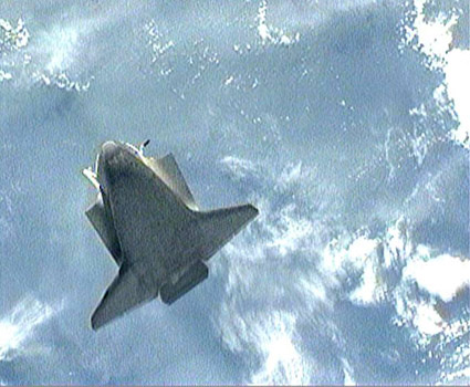 Atlantis performed a belly flip prior to docking with ISS on 18 November 2009 while station astronauts snapped hundreds of digital images looking for any signs of damage to the heat shield crucial for a safe reentry. Credit: NASA TV