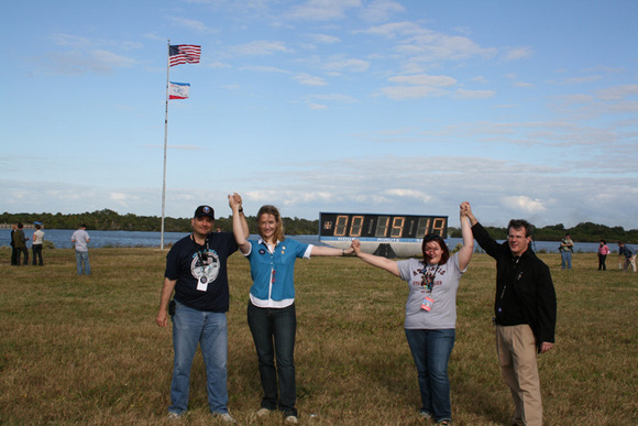 Ken Kremer met up with a group of lucky Tweeters at the KSC press center a few minutes after Atlantis blast off. Back dropped by the world famous countdown clock, pad 39 A. Do you think they are having a blast? Credit: Ken Kremer