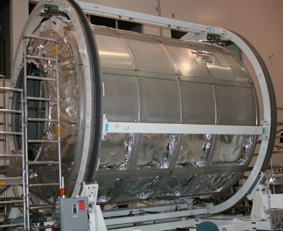 ‘Donatello’ MPLM module inside the Space Station Processing Facility at KSC. This module is being utilized for spare parts. Outer shielding is being removed. Credit: Ken Kremer