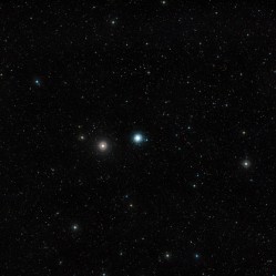 This wide-field image of the sky around the globular cluster Messier 30 was created from photographs forming part of the Digitized Sky Survey 2. Located about 28 000 light-years away from Earth, this cluster -- a swarm of several hundred thousand stars -- is about 90 light-years across. The field of view is approximately 2.9 degrees across. Credit: ESO and Digitized Sky Survey 2 Acknowledgment: Davide De Martin This wide-field image of the sky around the globular cluster Messier 30 was created from photographs forming part of the Digitized Sky Survey 2. Located about 28 000 light-years away from Earth, this cluster -- a swarm of several hundred thousand stars -- is about 90 light-years across. The field of view is approximately 2.9 degrees across. Credit: ESO and Digitized Sky Survey 2 Acknowledgment: Davide De Martin