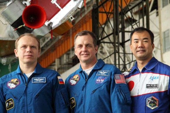 The Expedition 22 crew poses for a group snapshot while visiting the Soyuz launch vehicle assembly facility in front of the rocket's third stage. Crew members are, from the left, Russian cosmonaut Oleg Kotov, Soyuz commander; NASA astronaut T.J. Creamer, flight engineer; and Japan Aerospace Exploration Agency astronaut Soichi Noguchi, flight engineer. Photo credit: NASA/Victor Zelentsov