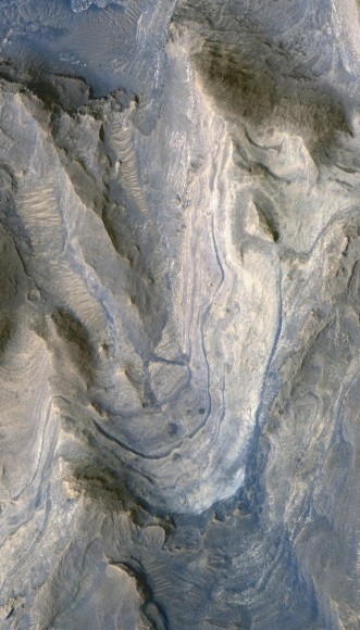 Layers of rock exposed in the lower portion of a tall mound near the center of Gale Crater on Mars exhibit variations in layer thickness and range between dark and light tones. Image credit: NASA/JPL-Caltech/University of Arizona
