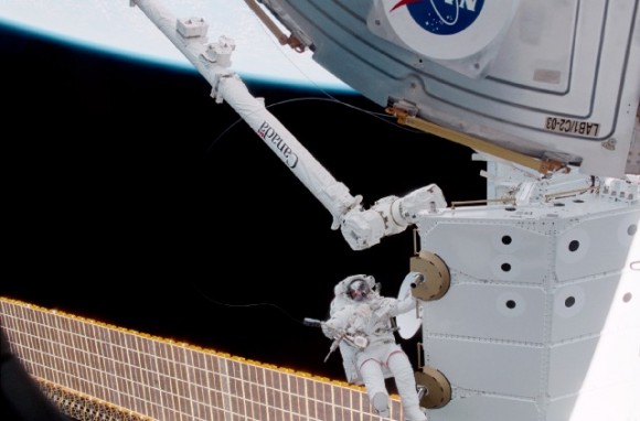 Chris Hadfield during an EVA in 2001. Also in the image is the Canadarm2 robotic arm on the ISS. Credit: NASA
