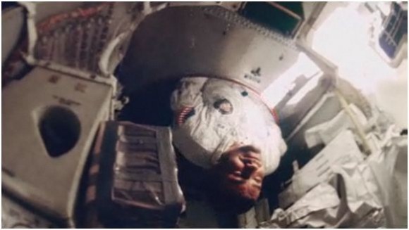 Screenshot from Apollo 13 footage of Fred Haise floating through the hatch between Odyssey and Aquarius. Credit: NASA