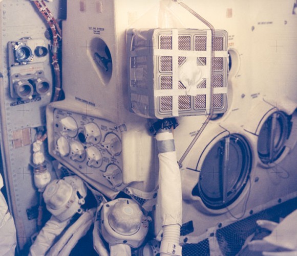 The Apollo 13 fix -- complete with duct tape -- of making a square canister fit into a round hole. Credit: NASA