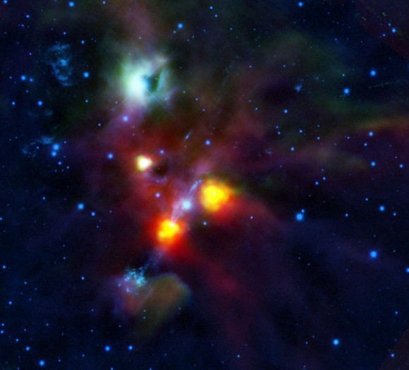 The black spot in the green-tinged cloud near the top of the image is a hole blown through NGC 1999 by the jets and winds of gas from the young stellar objects in this region of space. Credits: ESA/HOPS Consortium