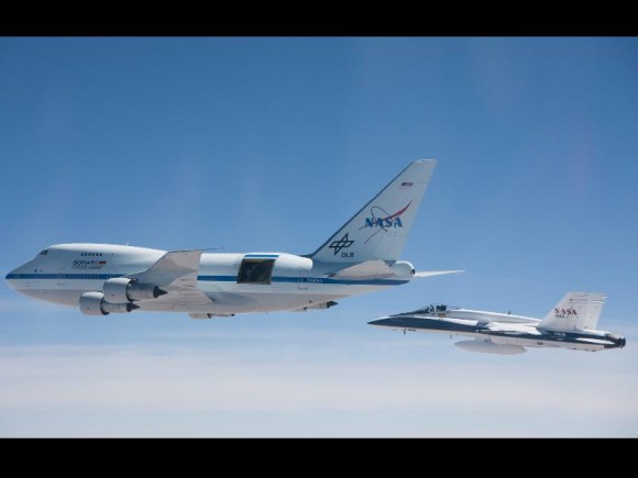 With a NASA F/A-18 flying safety chase nearby, NASA's Stratospheric Observatory for Infrared Astronomy – or SOFIA – flies a test mission over the Mojave Desert with the sliding door over its 17-ton infrared telescope open. Credit: NASA/Jim Ross