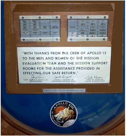 A plaque from the three Apollo 13 astronauts thanking the mission support teams. Note the panels of the caution and warning system above the signatures. That was my system, said Woodfill. The alarm system personified what the team’s role was providing caution, warning, and assistance for the crew’s safety. Image Courtesy Jerry Woodfill