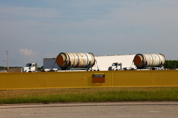 Used SRB sections drive past while ET-138 is being unloaded at KSC. Credit: Alan Walters (awaltersphoto.com) for Universe Today
