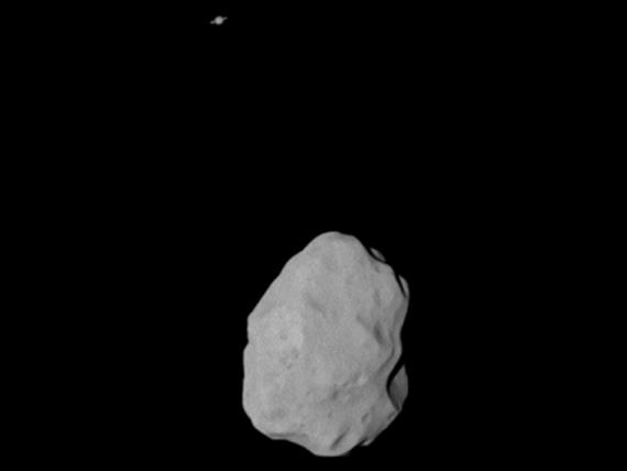 At a distance of 36,000 kilometers (22,369 miles) the OSIRIS Narrow Angle Camera (NAC) took this image catching the planet Saturn in the background. Image credit: ESA 2010 MPS for OSIRIS Team MPS/UPD/LAM/IAA/RSSD/INTA/UPM/DASP/IDA
