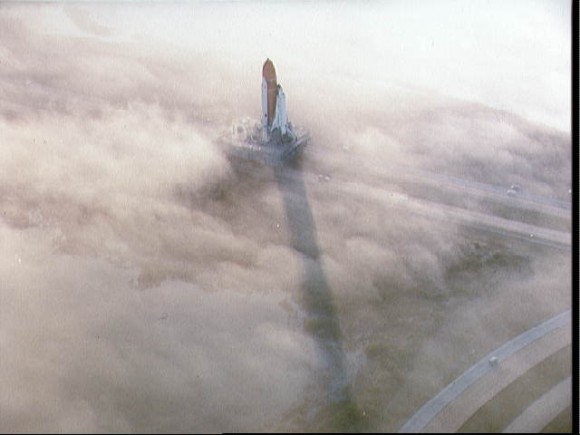 Two views of the Challenger being rolled out to pad 39A in the fog STS-6 Two views of the Challenger being rolled out to pad 39A in the fog STS-6