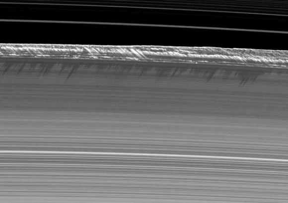 Vertical structures, among the tallest seen in Saturn's main rings, rise abruptly from the edge of Saturn's B ring to cast long shadows on the ring in this image taken by NASA's Cassini spacecraft in 2009.