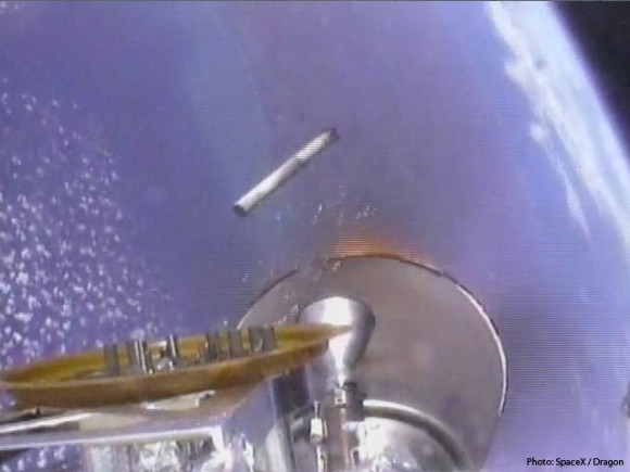 After stage separation, flames are barely visible around nozzle as the second stage engine ignites and the first stage falls back to the Earth below. Credit: SpaceX