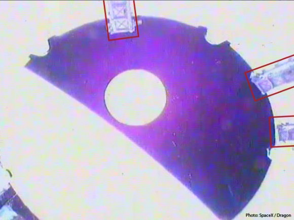 High contrast view of the Dragon spacecraft (circle at center) viewed from the top of the second stage as it departs over the curved horizon of the Earth. The rectangles indicate locations of three of the nano satellite deploying P-PODs carried on this mission. Credit: SpaceX