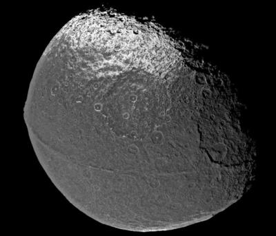 A ridge that follows the equator of Saturn's moon Iapetus gives it the appearance of a giant walnut. This image was taken by the Cassini spacecraft. Credit: NASA/JPL/SSI