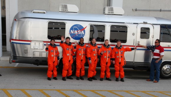 The STS-133 crew in front of the 'Astro Van' that brings them to the launchpad. Credit: Alan Walters (awaltersphoto.com) for Universe Today.