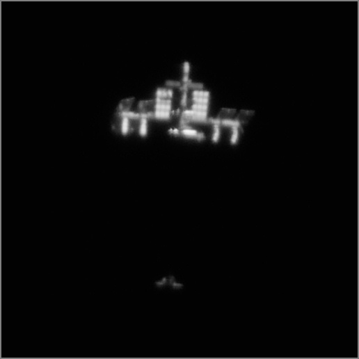 The International Space Station and shuttle Discovery, about 30 minutes before docking, as seen from Earth. Credit: Theirry Legault.