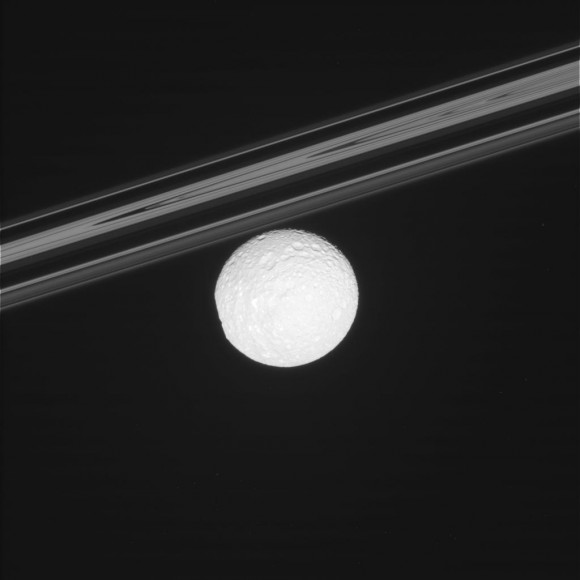 This view shows the bright, icy Mimas in front of Saturn's delicate rings. Image credit: NASA/JPL/SSI