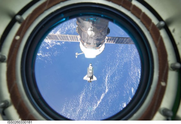 Backdropped by a blue and white part of Earth, space shuttle Discovery is featured in this image photographed by an Expedition 26 crew member as the shuttle approaches the International Space Station during STS-133 rendezvous and docking operations. Docking occurred at 2:14 p.m. (EST) on Feb. 26, 2011. A Russian Progress spacecraft docked to the space station is also featured in the image. Credit: NASA