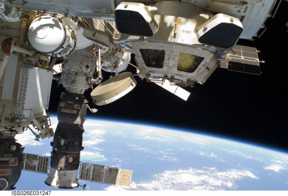 Backdropped by Earth's horizon and the blackness of space, this view shows the Cupola of the International Space Station and a docked Russian Progress spacecraft, taken during the STS-133 mission. Credit: NASA