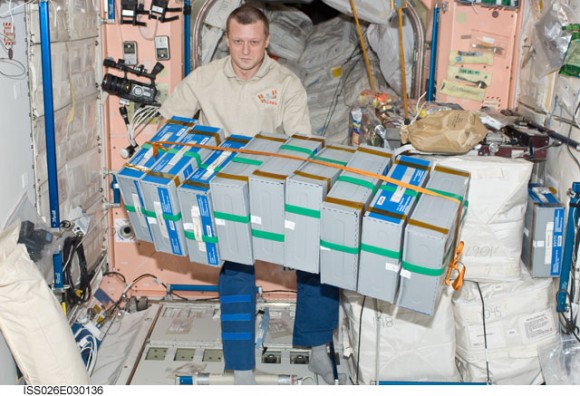 Russian cosmonaut Dmitry Kondratyev, Expedition 26 flight engineer, moves stowage containers in the Unity node of the International Space Station. Credit: NASA