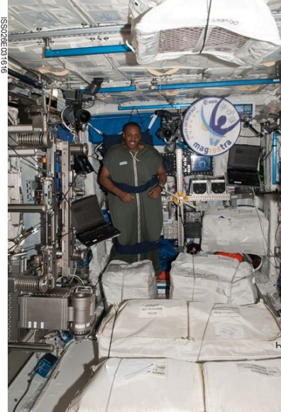 Alvin Drew, STS-133 mission specialist, is pictured in his sleeping bag, which is attached in the Columbus laboratory of the International Space Station. Credit: NASA