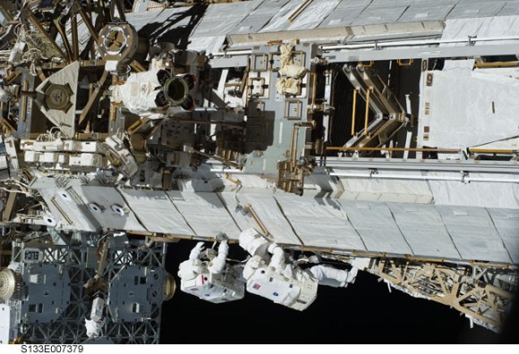 Astronauts Steve Bowen and Alvin drew work in tandem on one of the truss sections of the ISS during the first spacewalk of the STS-133 mission. Credit: NASA