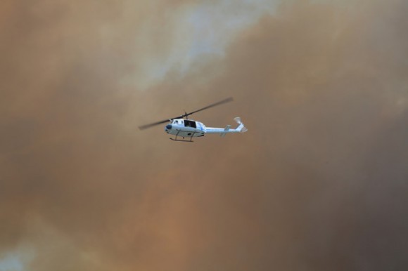 A helicopter flies through the smoke and haze at KSC on April 27 during the brushfire. Credit: Alan Walters.