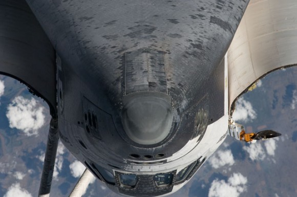 This view of the nose, the forward underside and crew cabin of Endeavour was taken by a crew member on board the ISS during a a photo survey of the approaching STS-134 crew, looking for potential problems in the thermal protection system. Credit: NASA